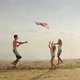 The Elder Brother Is Playing with His Sisters, Is Launching a Kite - VideoHive Item for Sale