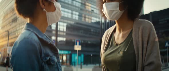 Video of two women greeting contactless on the street. Shot with RED helium camera in 8K. alt
