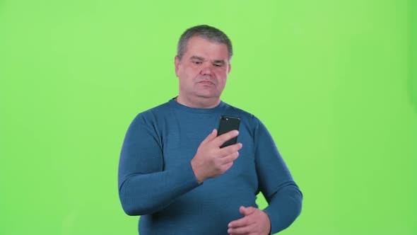 Man Does Selfie on His Smartphone. Green Screen alt