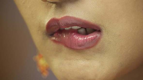 Close-up of young woman licking lips