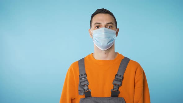 Builder Portrait with Face Mask Covid 19 Restrictions in Blue Background alt