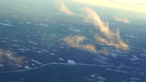 Plane soaring through cloud, aerial view of city and ocean slow motion video