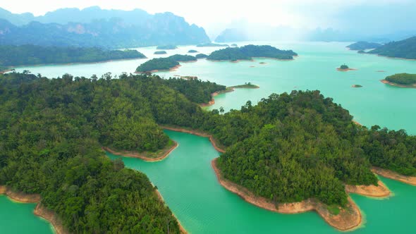 An aerial view from a drone flying over a dam, beautiful turquoise water alt