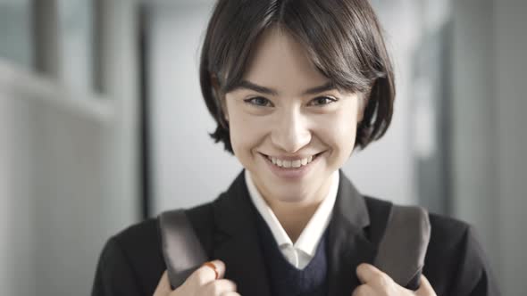 Headshot of Positive Beautiful Teenager Posing in School Corridor alt