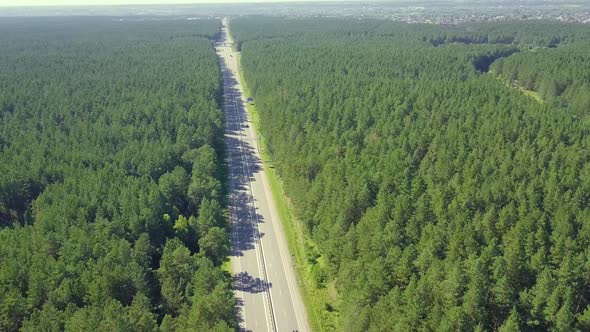 Aerial: Flying Back Over the Highway, Located in Dense Forest alt