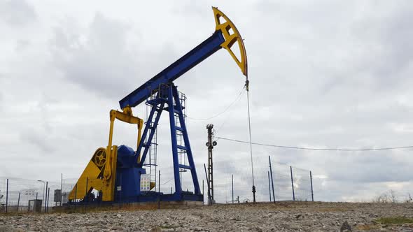 Oil pumpjack pumping sequentially oil from the ground near Ploiesti, Romania alt