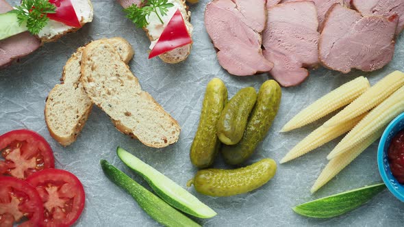 Cold appetizer. Cold cuts. Different snacks on a white crumpled paper, from above.