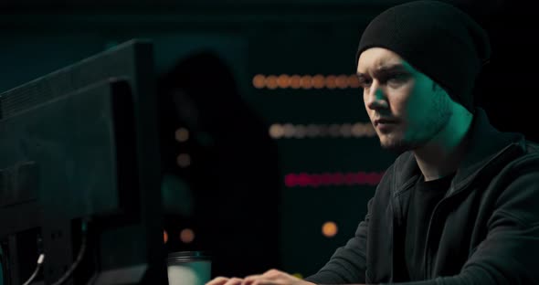 Dangerous Hooded Hacker Breaks Into Government Data Servers and Infects Their System with a Virus alt