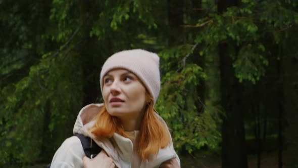 Medium shot of woman walking back and fourth being inspired by natures beauty. alt