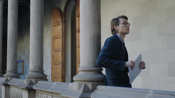 Student Holding Notebook in Hallway alt