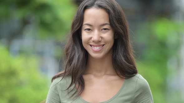 Young Happy Beautiful Multi-ethnic Woman Smiling Outdoors alt