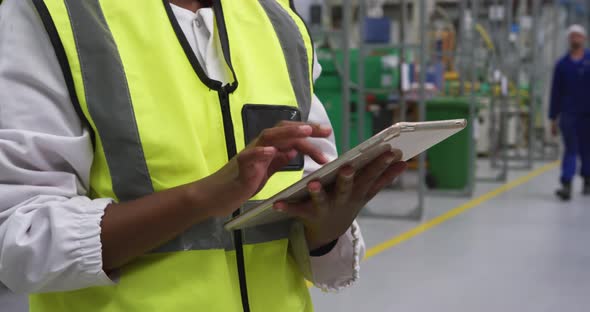 Warehouse female worker using digital tablet alt