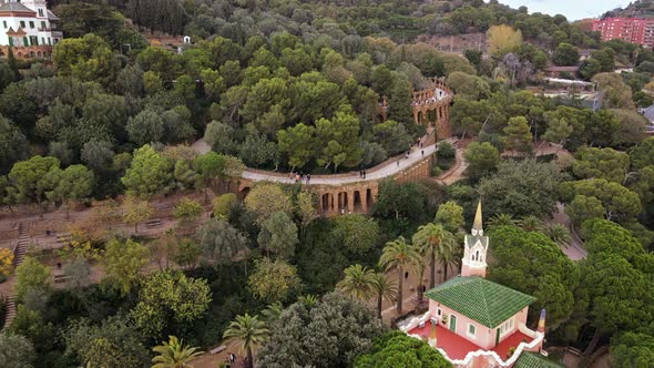Aerial drone view of Barcelona, Spain. Park Guell with tourists, a lot of greenery alt