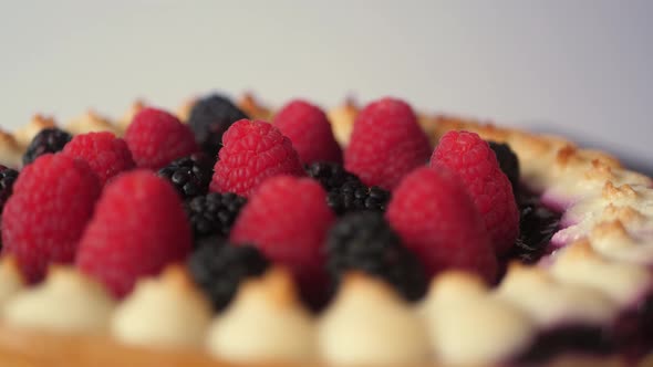 A piece of the Tasty Forest Fruit Torte twisting against a white background