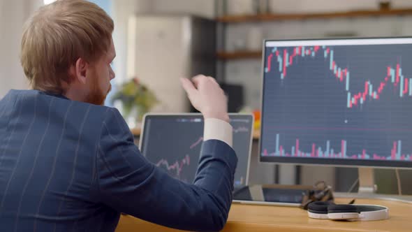 Businessman Looking at Statistics of your Earnings and Feeling Depressed alt