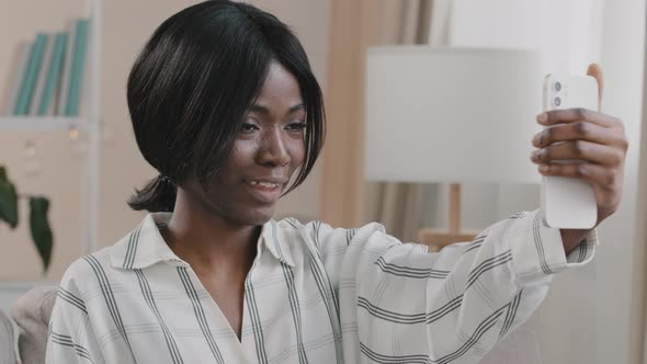 Young Happy Woman Chatting Friendly Via Video Call Holding Smartphone Looking at Phone Webcam alt