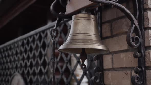 A Bronze Bell Hanging on the Wall Near the Gate