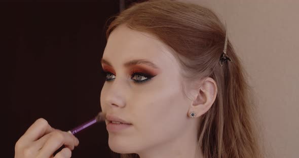 Beautiful girl has her makeup done in a beauty salon