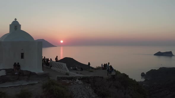 People Tourists Enjoying the Sunset From Church Viewing Point Over Island in Greece alt