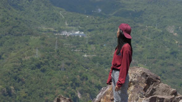 Asian Young Woman Looks At The Mountain and Looks Around in Asia Travels Through the Jungle Among alt
