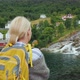 A Woman Admires the Norwegian Village and the Waterfall - VideoHive Item for Sale