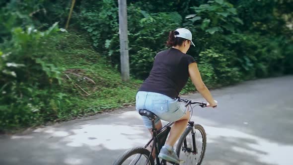 Overweight Woman Riding a Bike Slowly Weight Loss Problems Exercise Fitness
