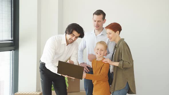 Young Family Talking with Apartment Landlord From Real Estate Agent Via Laptop