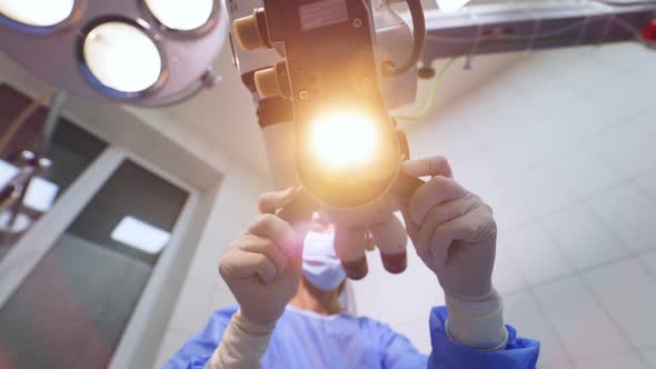 Patient under surgical microscope. Doctor using microscope for work at operating room alt