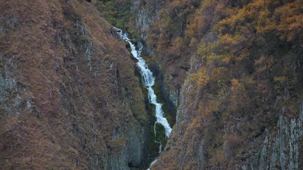 Narrow waterfall in autumn