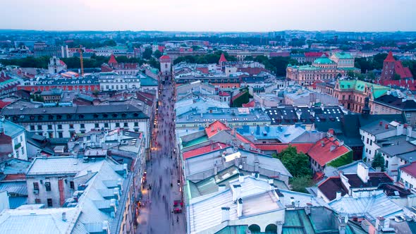 Poland Krakow rooftop timelapse at subset red roof tiles street lights birds eye view houses from to alt