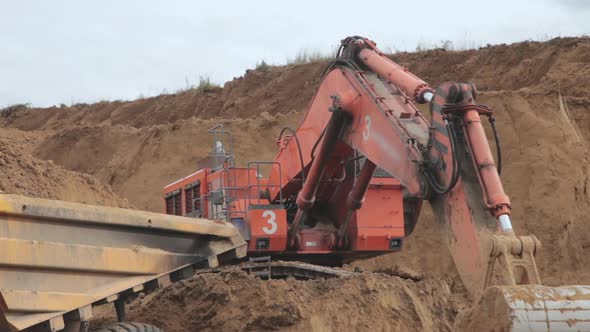 Excavator Bucket Digs Coal