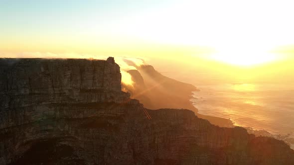 Cinematic Shot of Table Mountain at Sunset with the Ocean in the Background