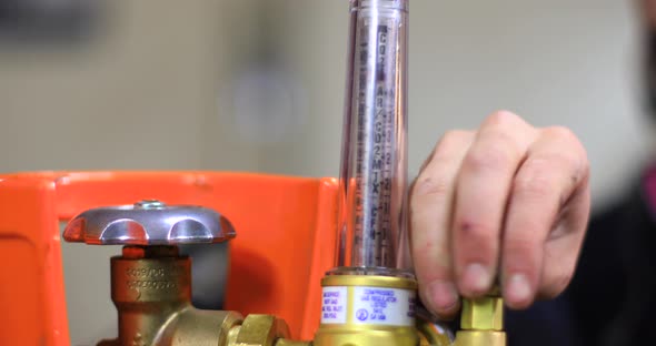 Woman Adjusting Welding Machine Pressure Gauge alt