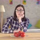 Young Woman Looks at Tomatoes Which Cause an Allergic Reaction