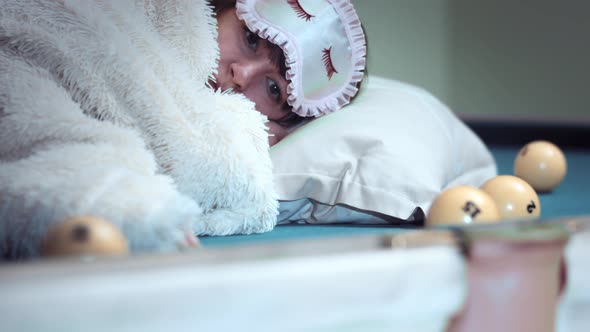 Sad Depressed Woman Lies on a Billiard Table and Rolls Balls Into the Hole Cinematic Shot alt