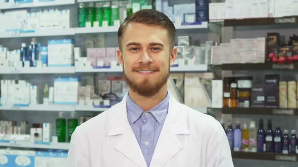 Young Pharmacist Showing Medication and Smiling alt