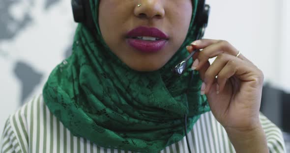 African Islamic Businesswoman with Hijab Wearing a Headset While Standing in the Modern Office alt