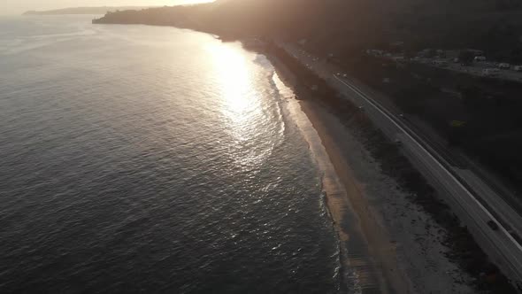 Sunset on the PCH 1 in Malibu, California.  Shimmering waves at the beach. alt
