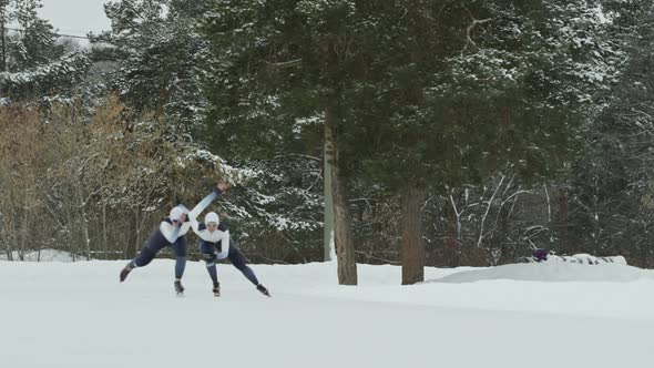 Speed Skaters Training in Outdoor Ice Rink alt