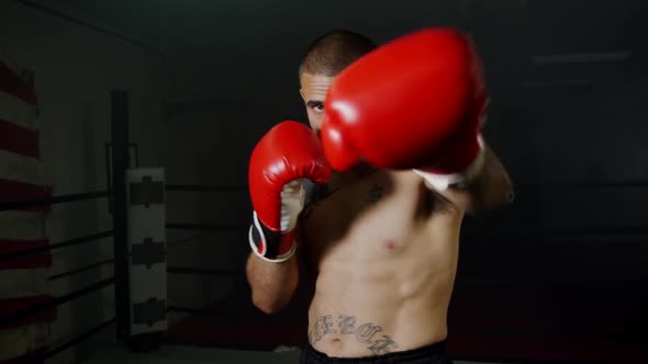 Strong Boxer With Red Gloves Practice Punching 20