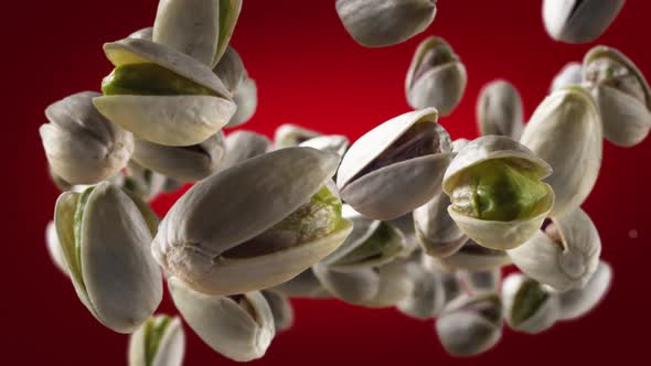 Flying of Pistachios in Deep Red Background alt