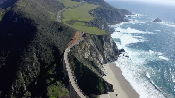 Cars move across the bridge. alt
