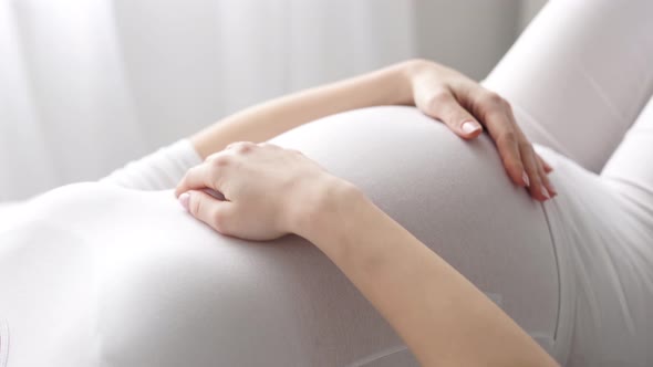 Pregnancy. Pregnant Woman Touching Baby Belly Closeup alt