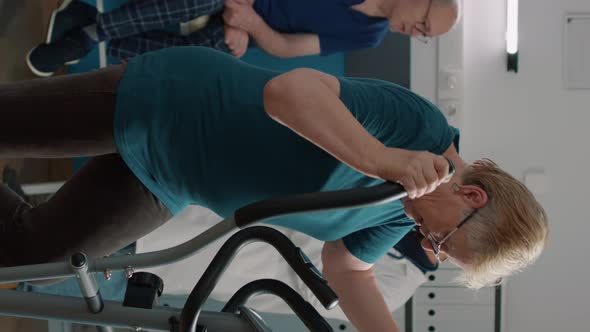 Vertical Video Portrait of Senior Woman Doing Physical Therapy on Stationary Bicycle alt