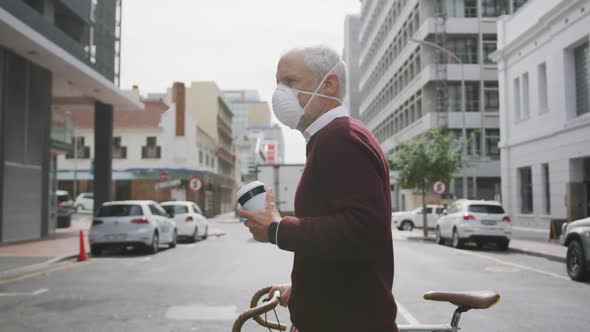 Caucasian man out and about in the street wearing on a face mask against coronavirus alt