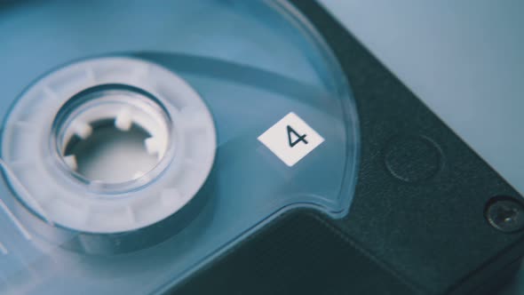 Motion Over Compact Cassette with Tape on White Background alt