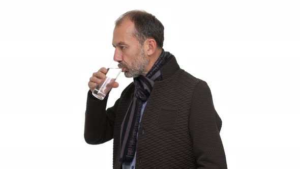 Halfturn Portrait of Mature Goodlooking Gentleman Wearing Jacket and Scarf Being Thirsty Drinking alt