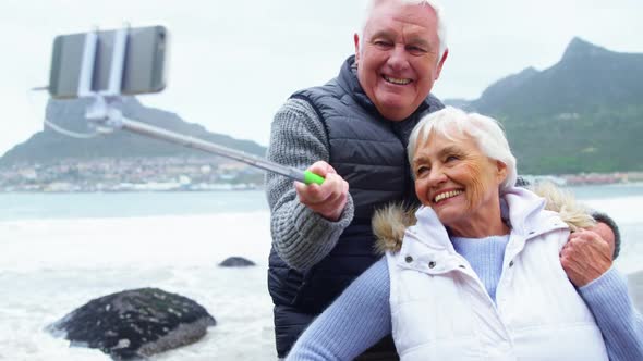 Senior couple taking a selfie from selfie stick alt