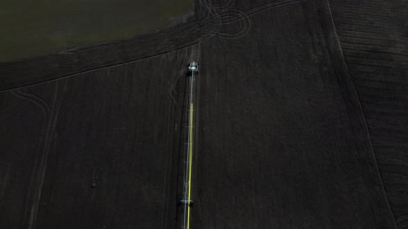 Aerial drone view drip irrigation watering system in agricultural farm field alt