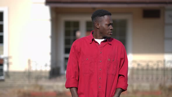 Portrait of Confident Millennial African American Man Gesturing Thumb Up Smiling Looking at Camera alt